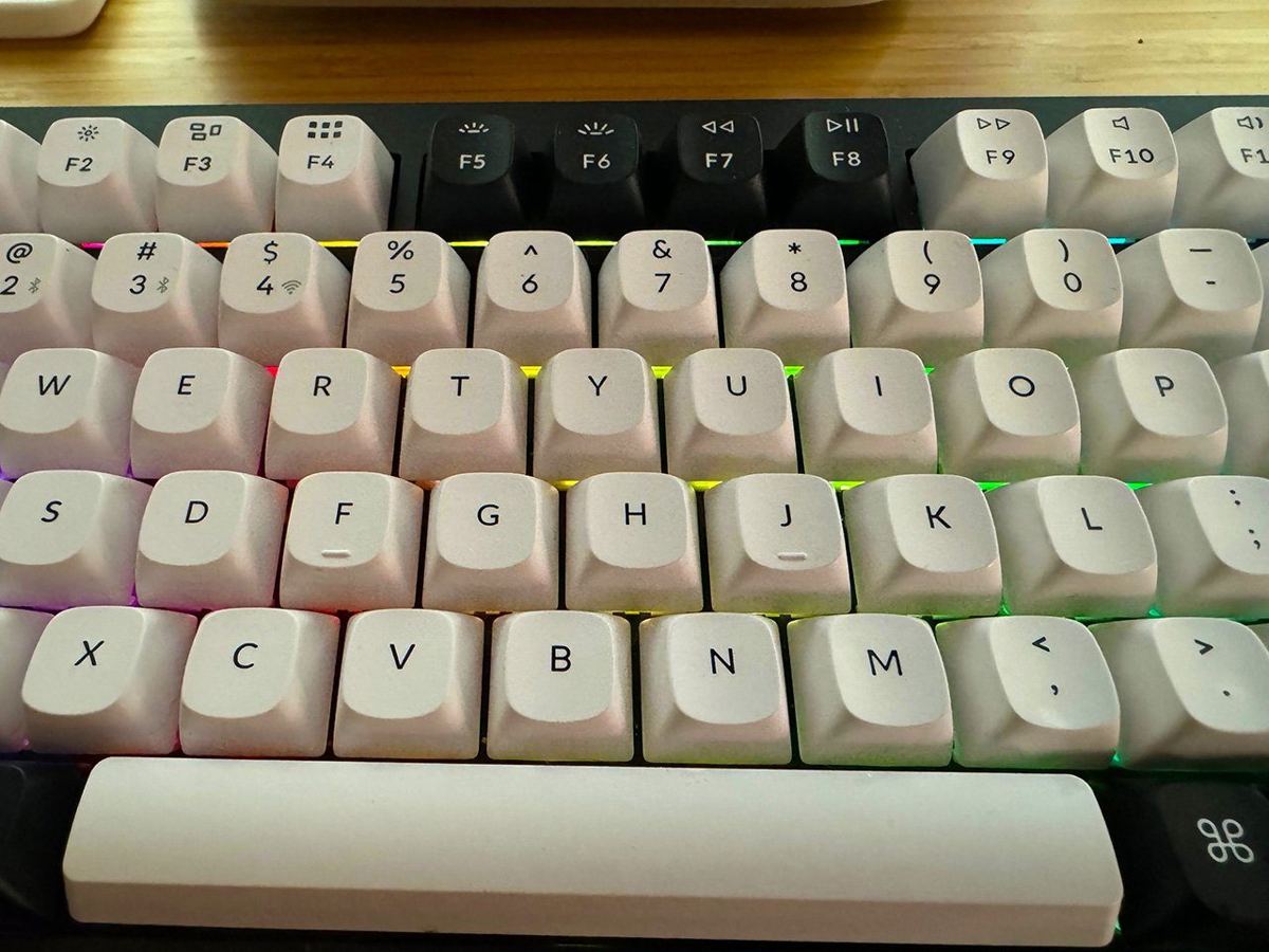 Close-up of a mechanical keyboard with backlit keys and a spacebar in view.