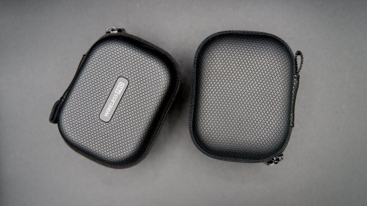 Two black zippered pouches with textured surfaces on a gray background; one says 'Wireless Pro.'
